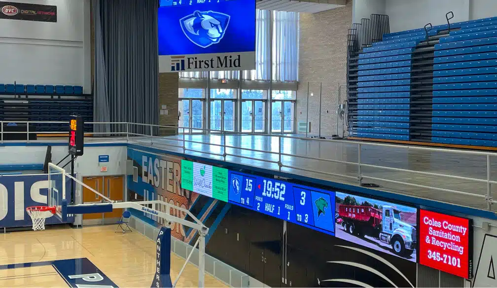 LED ribbon board with sponsor logos above a Panthers basketball court